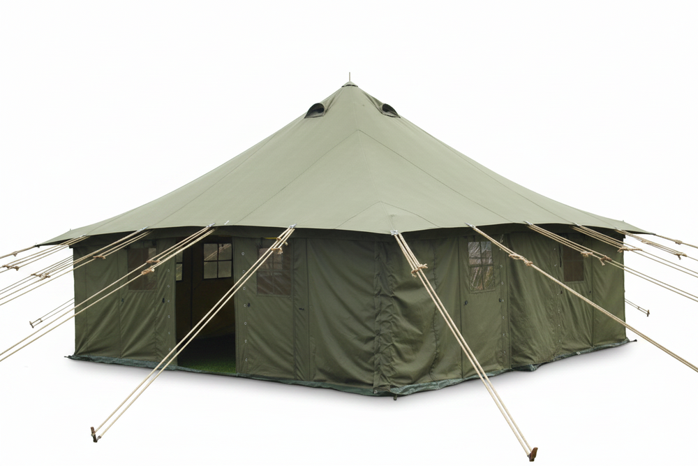 Large green tent on grass with buildings and power lines in the background